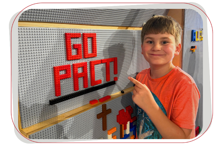 boy with legos spelling out go pact